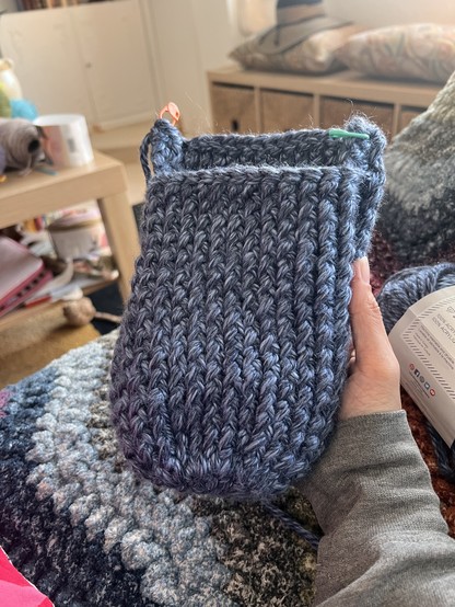The toe and instep part of a slipper. I’ve only just started the heel

It’s a light and dark blue heathered super chunky yarn