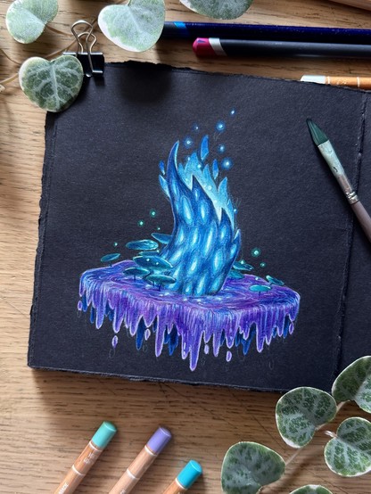 A photo of an open, square, black paper sketchbook with hand-ripped edges, placed on a wooden desk and surrounded by coloured pencils, a paint brush, and leaves for decoration. The sketchbook page features a seemingly shattered tree stump, a bright blue glow emanating from its core both on top and through elongated holes in its bark. The stump is standing in purple, swampy water that drips off the edges of a vague ellipse. Round, dark green leaves grow in the water.