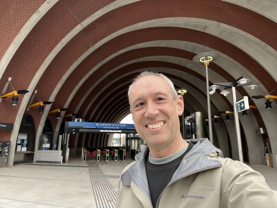 Daniel at the arched entrance to Arden station