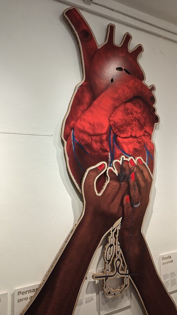 A pop art art exhibition of hands holding a heart